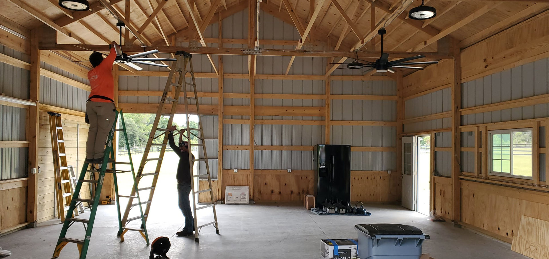 Electrician working inside barn structure
